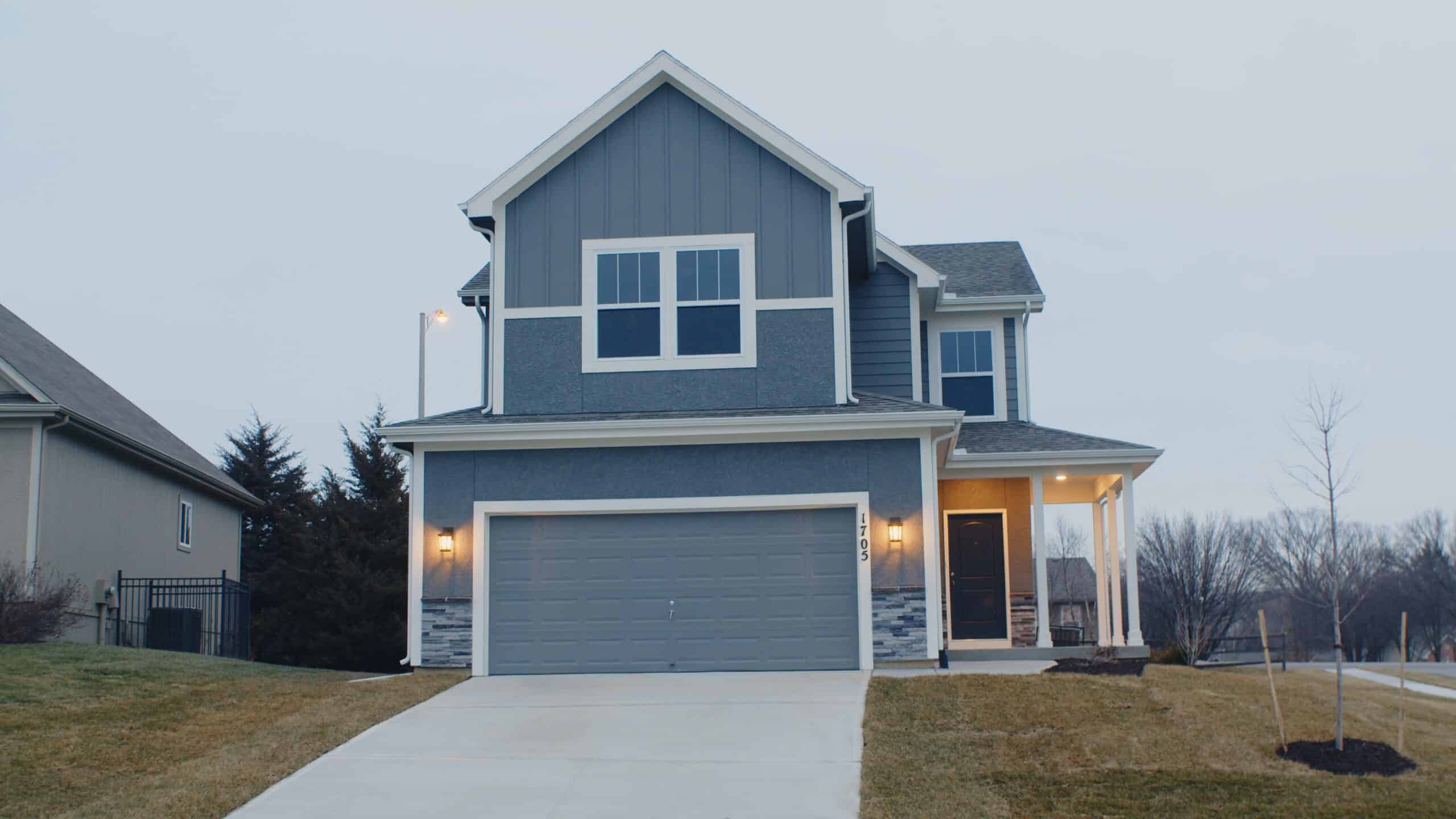 a two-story house painted dove gray with white trim.