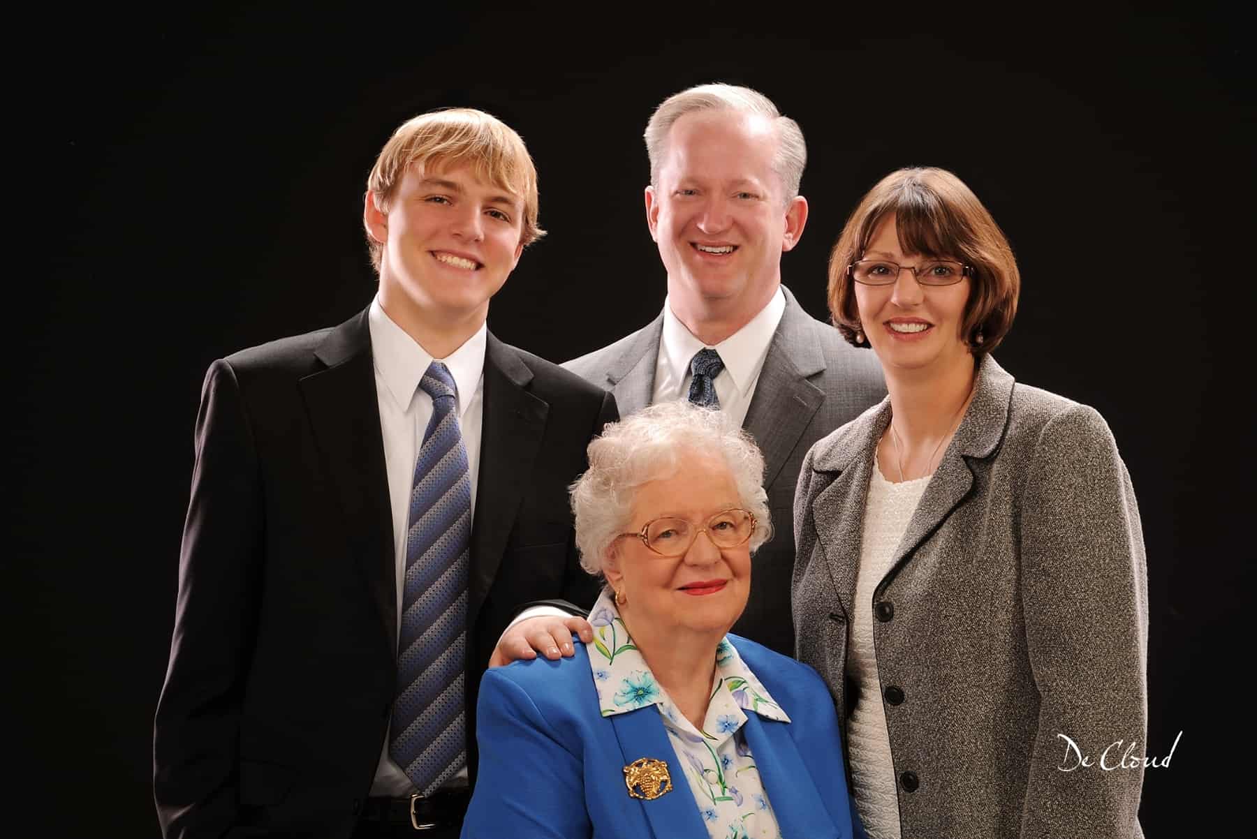 family photo with a father and mother, son, and grandmother