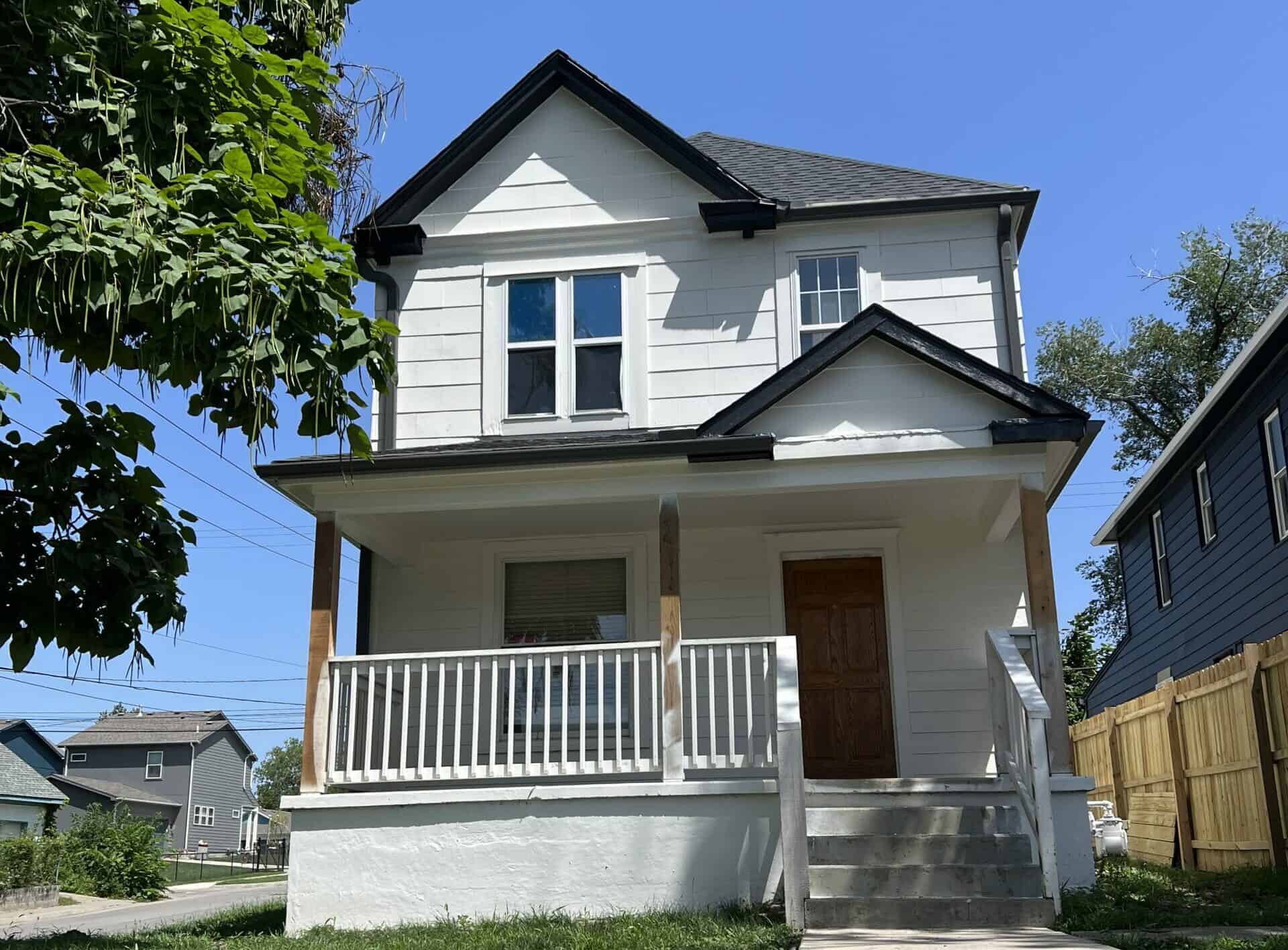 white 2 story house with a porch