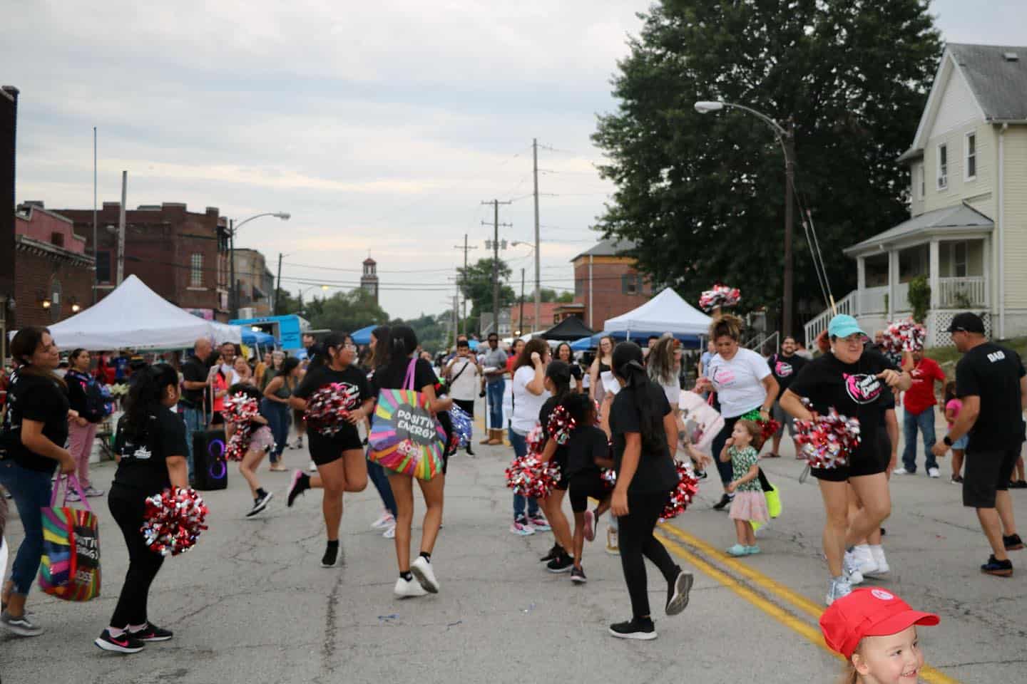 Families gather along 6th Street, which is filled with many artist and food vendor booths.