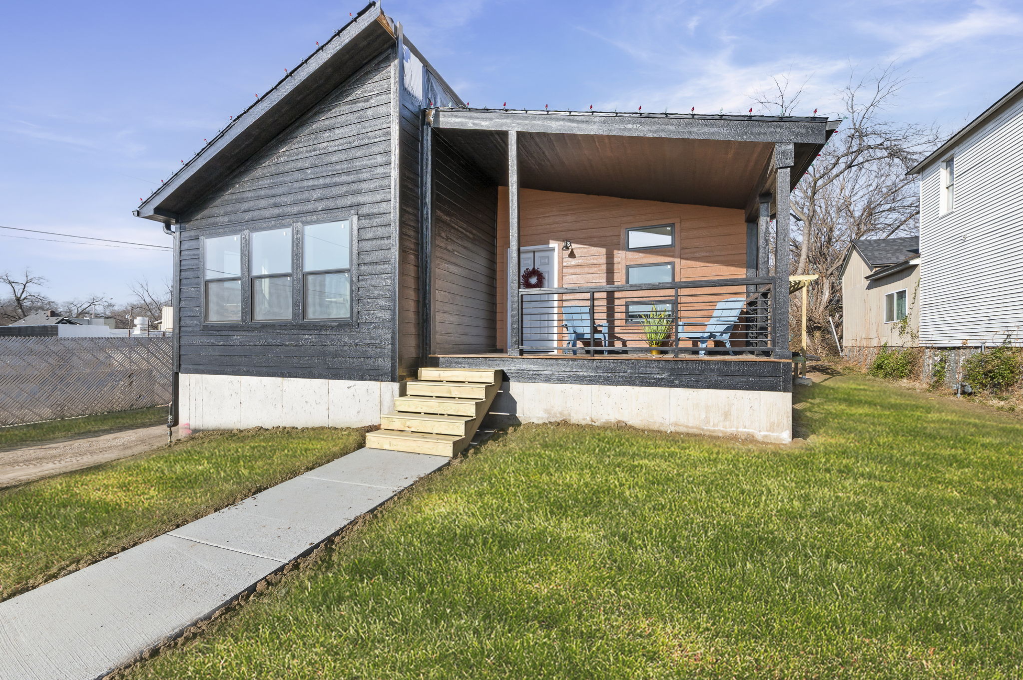 A single story home with a cute and cozy front porch.