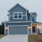 a two-story house painted dove gray with white trim.
